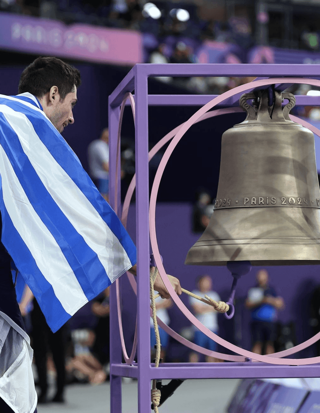 O Μίλτος Τεντόγλου χτυπά την καμπάνα του Stade de France. Όπως έκανε γνωστό ο manager Pierre-André Lacout, έχει κατασκευαστεί στο χυτήριο Cornille Havard στην περιοχή Villedieu-les-Poêles-Rouffigny της Νορμανδίας με χαραγμένο στην επιφάνειά της ‘Παρίσι 2024’, ως μέρος των εργασιών αποκατάστασης στη Νοtre-Dame, που προγραμματίζεται να έχουν ολοκληρωθεί μέχρι τον Δεκέμβριο και θα τοποθετηθεί σε έναν από τους πύργους της μετά τη λήξη τους. Όσο για την πίστα, όπου αγωνίζονται οι αθλητές δεν είναι κόκκινη αλλά στο χρώμα της βιολέτας για να συμβαδίζει με αυτό της διοργάνωσης. 
